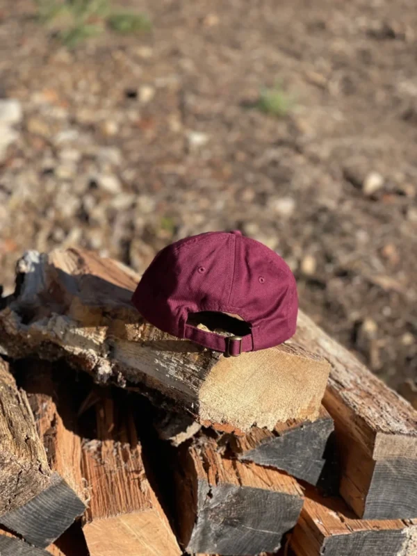 Burgundy cap placed on the wooden block