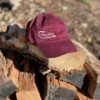 Burgundy cap placed on the wooden block